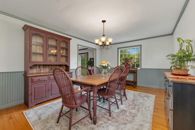 223 Deering Center Rd, Deering, NH 03244 - dining space with a chandelier, crown molding, a wainscoted wall, and light wood-style floors