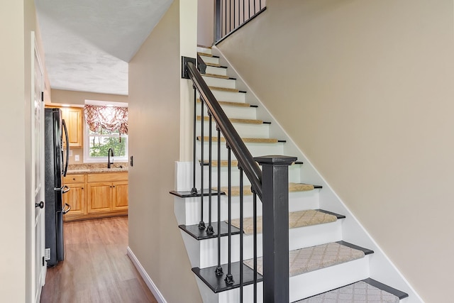 11 Woodhenge Cir, Londonderry, NH 03053 - staircase with wood finished floors and baseboards