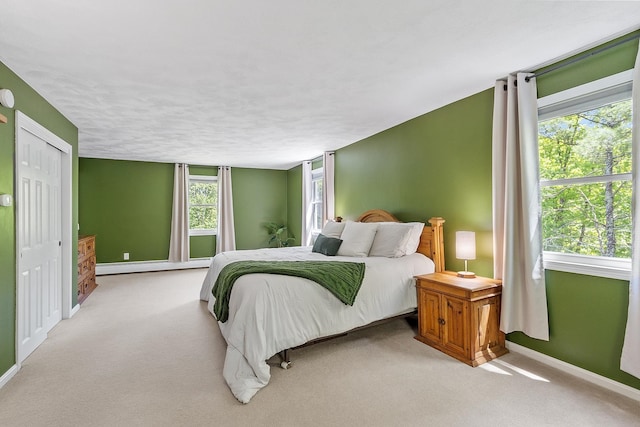 11 Woodhenge Cir, Londonderry, NH 03053 - bedroom featuring baseboards, light carpet, and baseboard heating