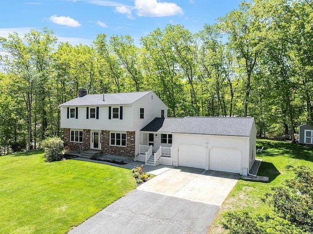 11 Woodhenge Cir, Londonderry, NH 03053 - colonial house with a garage, brick siding, a chimney, driveway, and a front yard