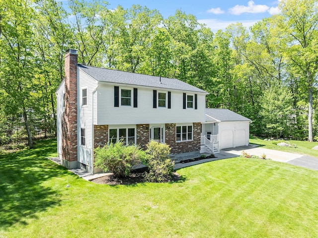 11 Woodhenge Cir, Londonderry, NH 03053 - colonial house featuring a chimney, driveway, an attached garage, a front lawn, and brick siding