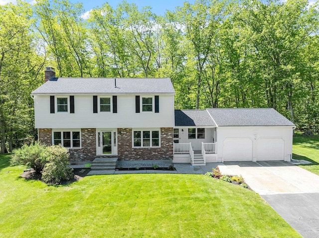 11 Woodhenge Cir, Londonderry, NH 03053 - colonial inspired home with a garage, a chimney, brick siding, a front lawn, and concrete driveway