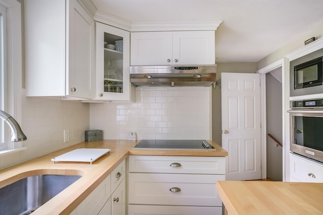 86 Pelham Rd, Salem, NH 03079 - kitchen featuring exhaust hood, stainless steel oven, black electric stovetop, a sink, and butcher block counters