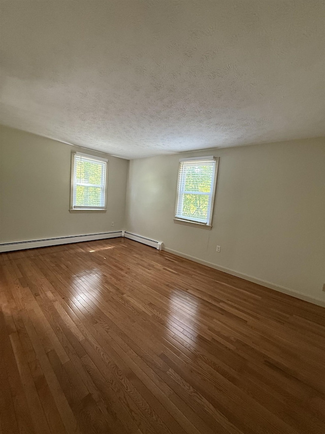 9 Quarry Rd, Hampstead, NH 03841 - unfurnished room with healthy amount of natural light, hardwood / wood-style flooring, baseboards, and a textured ceiling