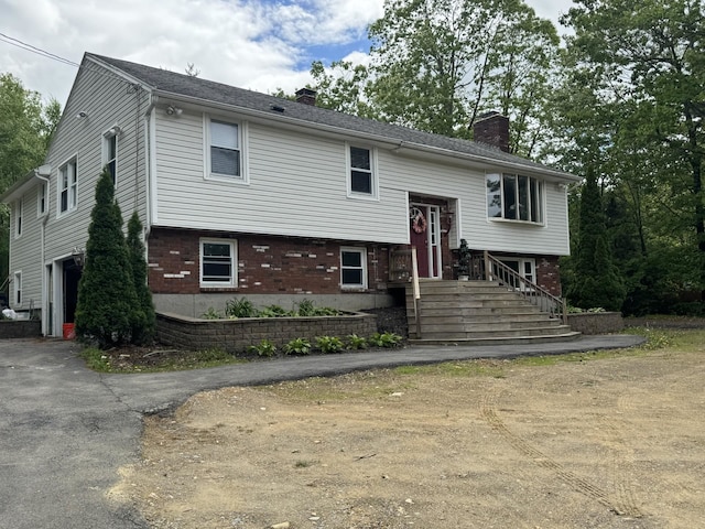 9 Quarry Rd, Hampstead, NH 03841 - raised ranch with a chimney, brick siding, and driveway