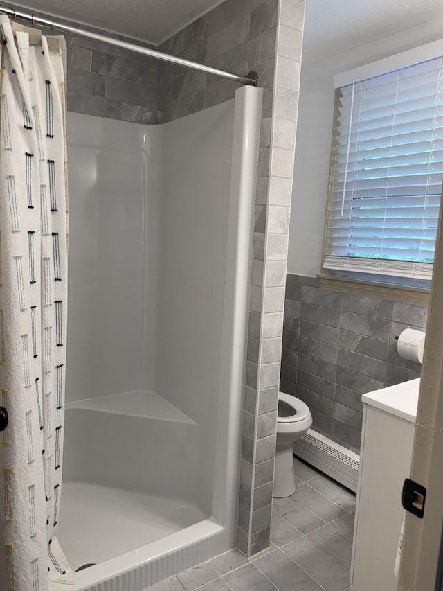 9 Quarry Rd, Hampstead, NH 03841 - full bathroom with a baseboard heating unit, toilet, a shower stall, tile walls, and vanity