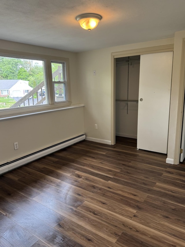 9 Quarry Rd, Hampstead, NH 03841 - unfurnished bedroom featuring a baseboard radiator, a closet, dark wood-style floors, and baseboards