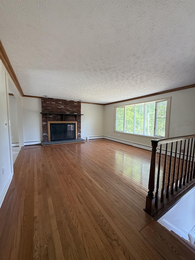 9 Quarry Rd, Hampstead, NH 03841 - unfurnished living room with a textured ceiling, wood-type flooring, crown molding, baseboards, and a fireplace