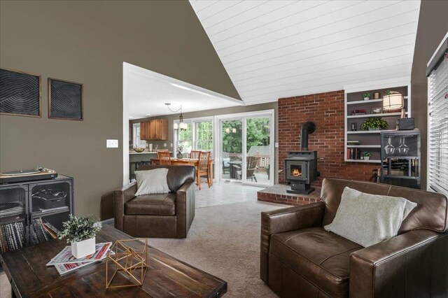 37 Level St, Merrimack, NH 03054 - carpeted living area with a wood stove and lofted ceiling