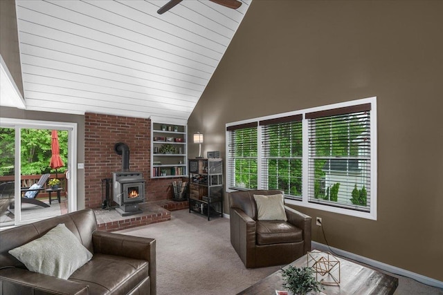 37 Level St, Merrimack, NH 03054 - carpeted living room with a wood stove, built in shelves, ceiling fan, baseboards, and high vaulted ceiling