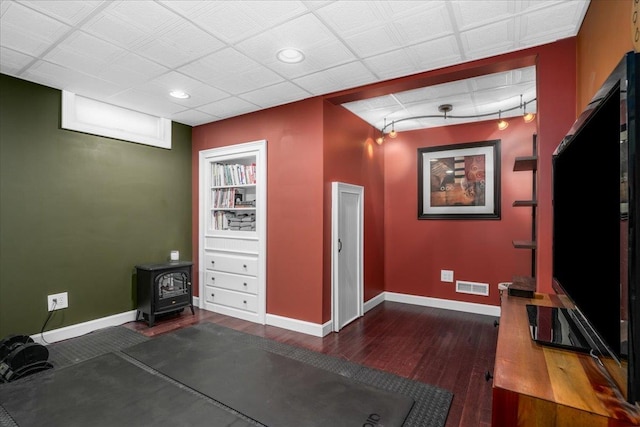 37 Level St, Merrimack, NH 03054 - interior space featuring a wood stove, baseboards, wood finished floors, and recessed lighting