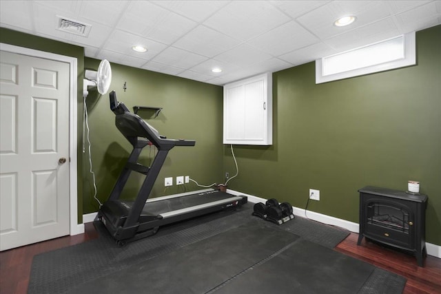 37 Level St, Merrimack, NH 03054 - exercise area featuring a wood stove, baseboards, wood finished floors, and recessed lighting