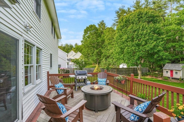 37 Level St, Merrimack, NH 03054 - wooden terrace with a fire pit and area for grilling