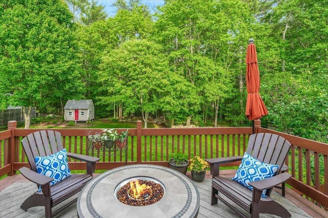 37 Level St, Merrimack, NH 03054 - wooden terrace featuring an outdoor fire pit, a lawn, and view of scattered trees
