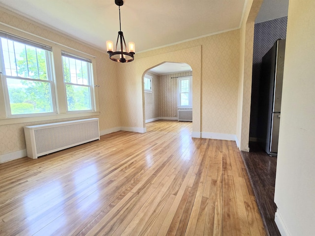 366 S Main St, Concord, NH 03301 - unfurnished dining area with radiator heating unit, arched walkways, hardwood / wood-style floors, crown molding, and a chandelier