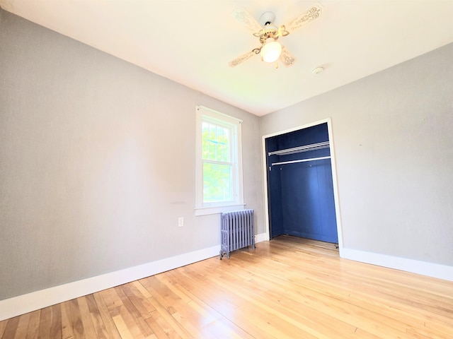 366 S Main St, Concord, NH 03301 - unfurnished bedroom featuring radiator heating unit, baseboards, light wood finished floors, and a closet