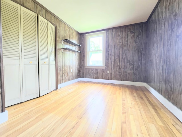 366 S Main St, Concord, NH 03301 - unfurnished bedroom with wood-type flooring, wood walls, and baseboards