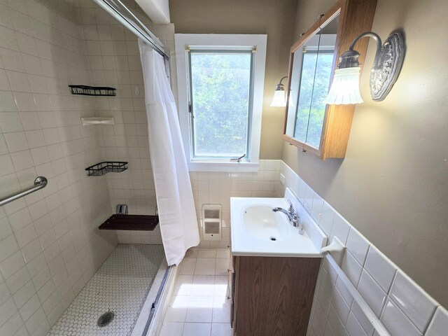 366 S Main St, Concord, NH 03301 - full bath featuring a tile shower, vanity, wainscoting, tile patterned floors, and tile walls