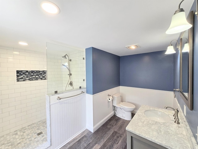 366 S Main St, Concord, NH 03301 - full bath featuring wood finished floors, wainscoting, vanity, a walk in shower, and toilet