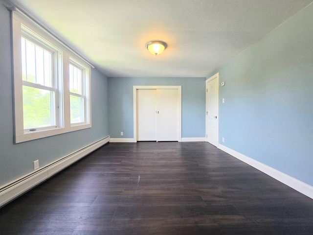 366 S Main St, Concord, NH 03301 - unfurnished bedroom with baseboard heating, dark wood-style floors, baseboards, and a closet