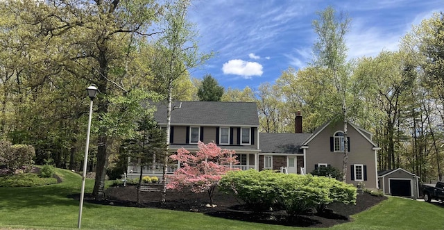 47 Blossom Rd, Windham, NH 03087 - back of house featuring a chimney, an outdoor structure, a yard, and a detached garage