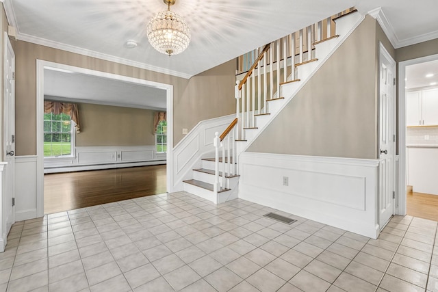 47 Blossom Rd, Windham, NH 03087 - tiled foyer entrance featuring a chandelier, stairway, a decorative wall, ornamental molding, and a wainscoted wall