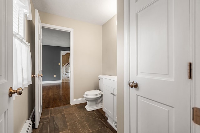 47 Blossom Rd, Windham, NH 03087 - half bathroom with toilet, baseboards, a baseboard heating unit, and vanity