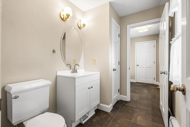 47 Blossom Rd, Windham, NH 03087 - bathroom featuring vanity, toilet, baseboards, and a baseboard radiator
