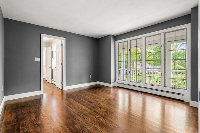 47 Blossom Rd, Windham, NH 03087 - empty room featuring baseboards, a baseboard heating unit, and wood finished floors