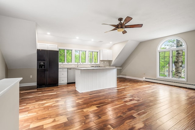 47 Blossom Rd, Windham, NH 03087 - kitchen with black fridge, baseboard heating, dishwasher, a ceiling fan, and light wood-type flooring