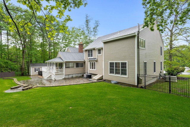 47 Blossom Rd, Windham, NH 03087 - rear view of house featuring a patio, cooling unit, and an outbuilding