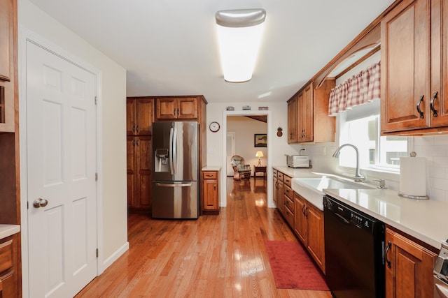 144 Whitten Rd, Milford, NH 03055 - kitchen featuring stainless steel refrigerator with ice dispenser, black dishwasher, a sink, and brown cabinetry