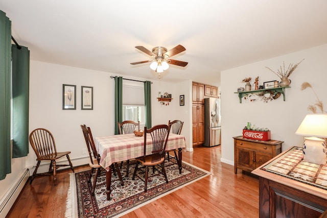 144 Whitten Rd, Milford, NH 03055 - dining room with a baseboard heating unit, light wood finished floors, and ceiling fan