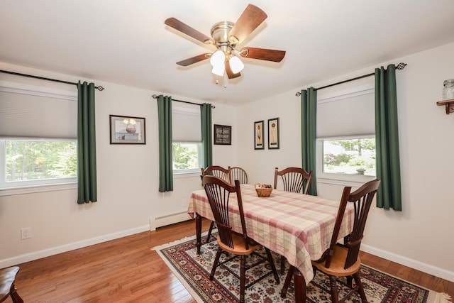 144 Whitten Rd, Milford, NH 03055 - dining space featuring baseboard heating, light wood-style flooring, ceiling fan, and baseboards