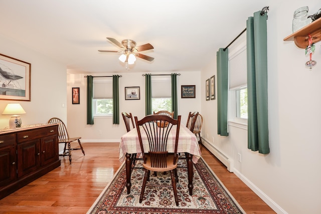 144 Whitten Rd, Milford, NH 03055 - dining area featuring a baseboard radiator, plenty of natural light, and light wood-type flooring
