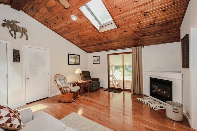 144 Whitten Rd, Milford, NH 03055 - living room with wood ceiling, wood finished floors, a skylight, a fireplace with flush hearth, and baseboards