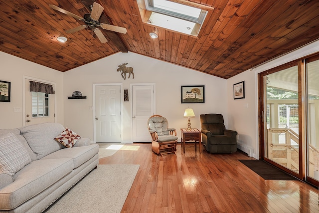 144 Whitten Rd, Milford, NH 03055 - living area with a baseboard radiator, light wood finished floors, a ceiling fan, a skylight, and wooden ceiling