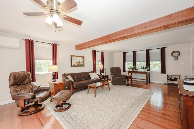 144 Whitten Rd, Milford, NH 03055 - living area featuring healthy amount of natural light, wood finished floors, a wall mounted AC, baseboards, and beamed ceiling