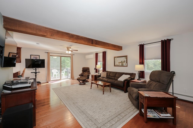 144 Whitten Rd, Milford, NH 03055 - living room featuring light wood-type flooring, a baseboard heating unit, a wall unit AC, beam ceiling, and a ceiling fan