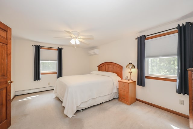 144 Whitten Rd, Milford, NH 03055 - bedroom featuring a baseboard heating unit, a wall mounted AC, light colored carpet, baseboards, and a ceiling fan