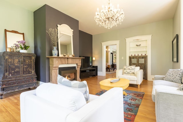 2 Streeter Hill Rd, Chesterfield, NH 03466 - living area featuring a chandelier, wood finished floors, a glass covered fireplace, and built in shelves