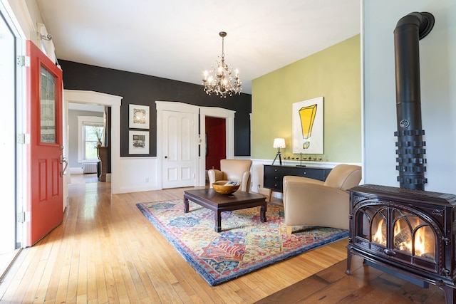 2 Streeter Hill Rd, Chesterfield, NH 03466 - living room with a wood stove, light wood finished floors, a chandelier, and baseboards