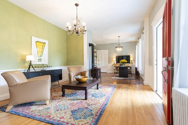 2 Streeter Hill Rd, Chesterfield, NH 03466 - living room with radiator heating unit, hardwood / wood-style flooring, a chandelier, and a wood stove
