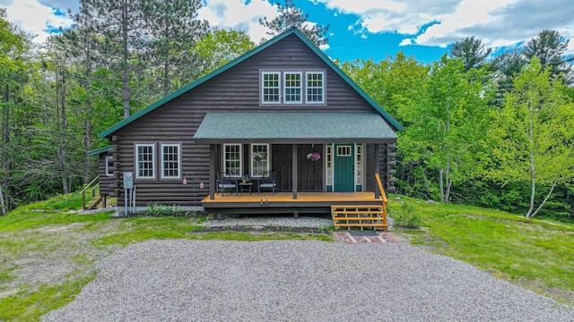 689 Hard Scrabble Rd, Sweden, ME 04008 - log home featuring log siding, roof with shingles, and a porch