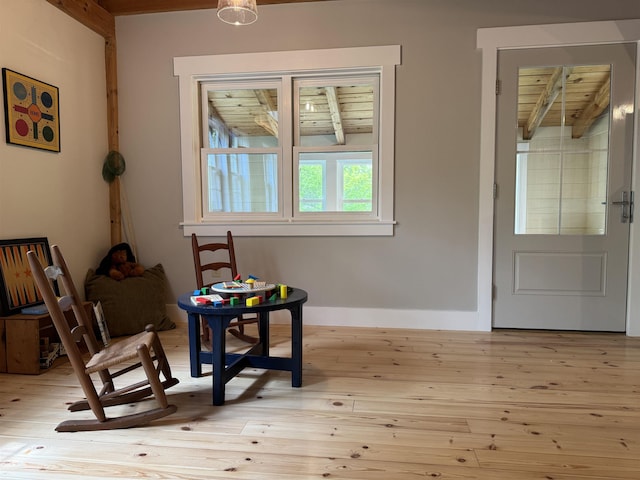689 Hard Scrabble Rd, Sweden, ME 04008 - living area with wooden ceiling with exposed beams, light wood finished floors, and baseboards