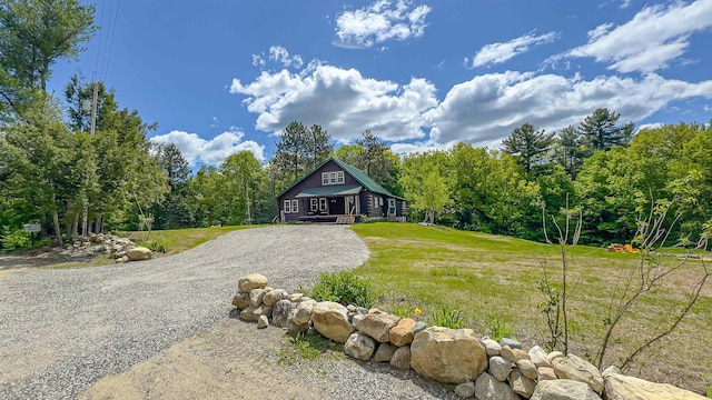 689 Hard Scrabble Rd, Sweden, ME 04008 - view of front of property featuring driveway, a front lawn, and a forest view
