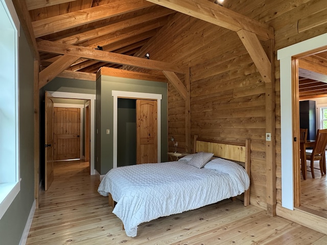689 Hard Scrabble Rd, Sweden, ME 04008 - bedroom featuring light wood-type flooring, wooden walls, and a closet