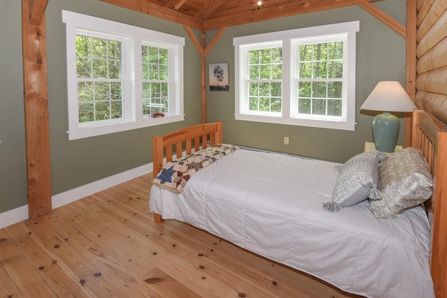 689 Hard Scrabble Rd, Sweden, ME 04008 - bedroom with lofted ceiling, wood-type flooring, and baseboards