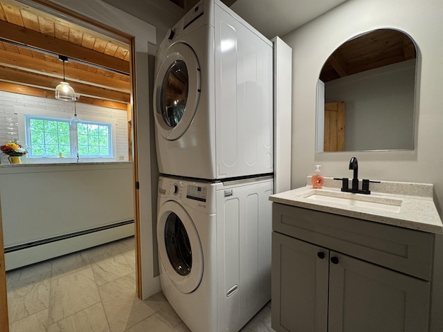689 Hard Scrabble Rd, Sweden, ME 04008 - laundry area with stacked washing machine and dryer, light marble finish flooring, a baseboard heating unit, and cabinet space