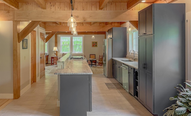 689 Hard Scrabble Rd, Sweden, ME 04008 - kitchen featuring a sink, a center island, stainless steel appliances, beam ceiling, and pendant lighting